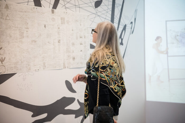 Woman looking closely at a detailed drawing